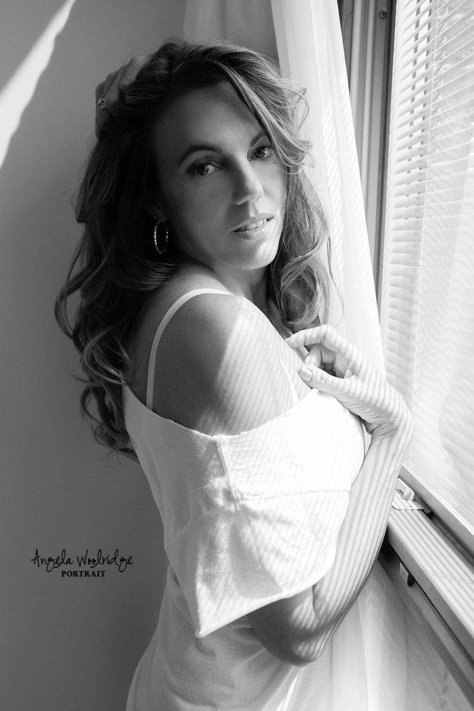 Sexy photo of woman in front of window