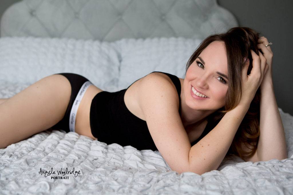 Joyful lady on bed in Columbus boudoir studio