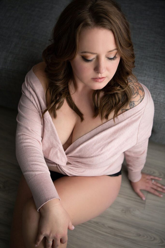 Intimate boudoir portrait capturing the natural beauty and grace of a plus size woman